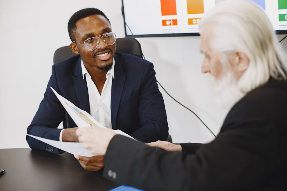 Business colleagues engaged in a collaborative meeting while reviewing documents in an office.